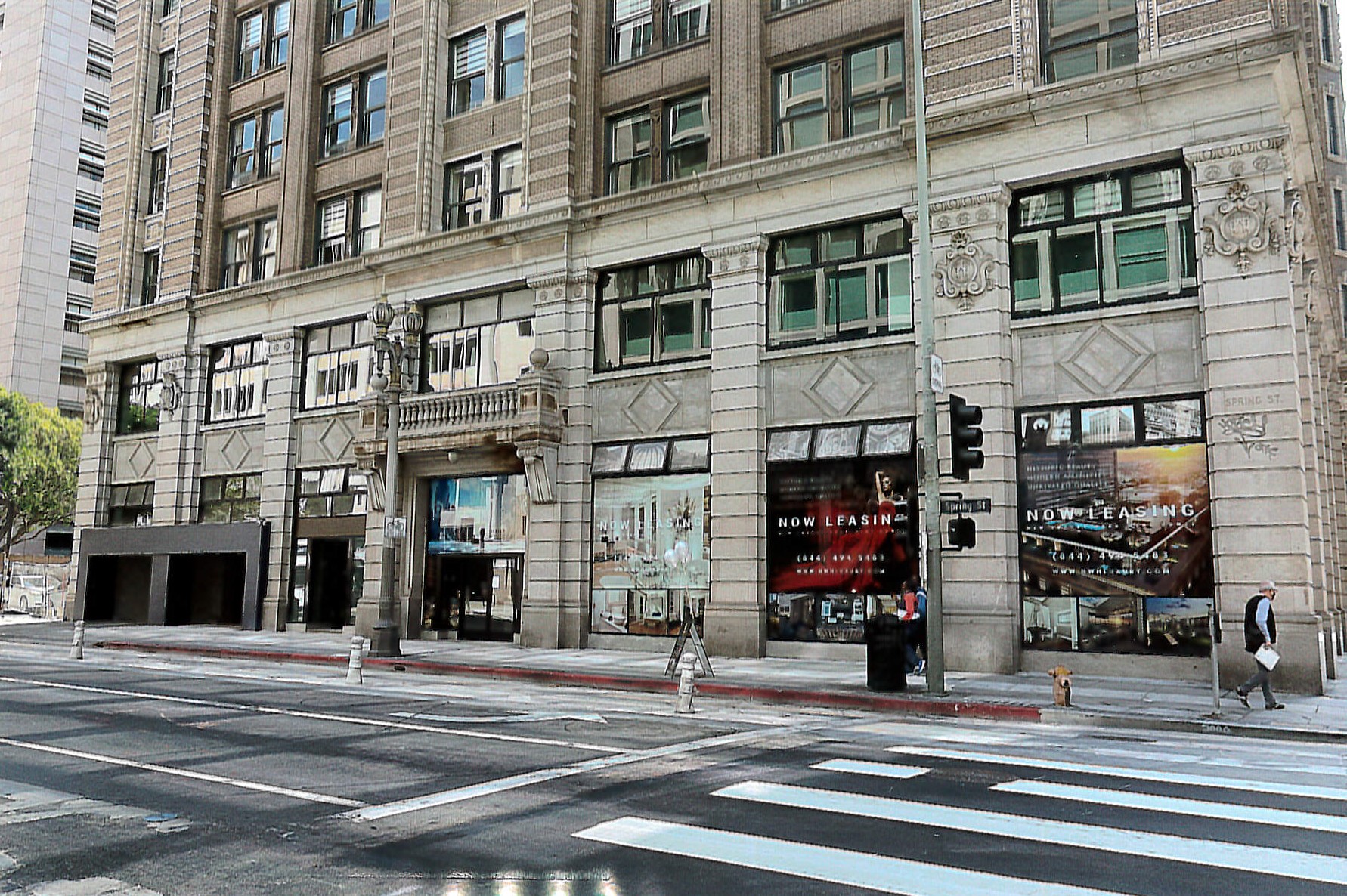 Rehabilitated View of west facade, hotel entrance and parking garage entrance and exit